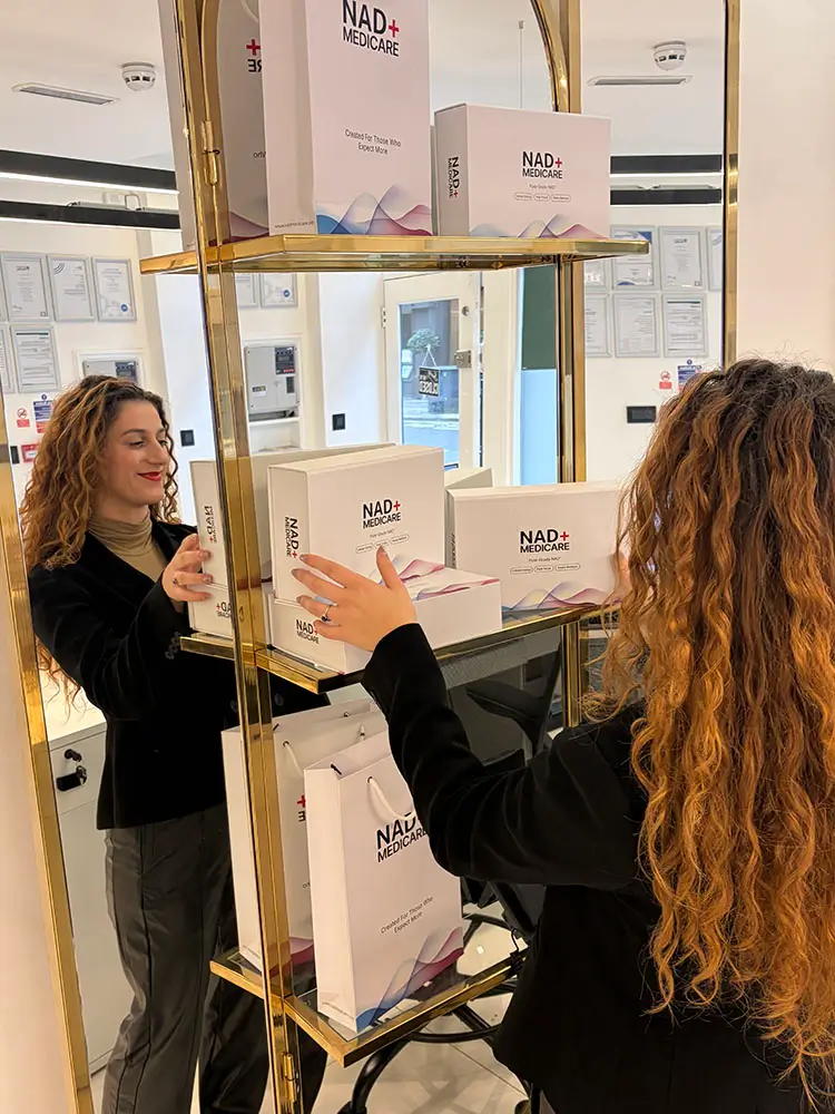 NAD+ Medicare boxes stocked on a gold display shelf in the clinic